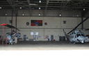 HML-167_Sign_from_MMAF_mounted_on_wall_of__HMLA-167_hanger_at_New_River_framed_by_Huey_and_Cobra.jpg